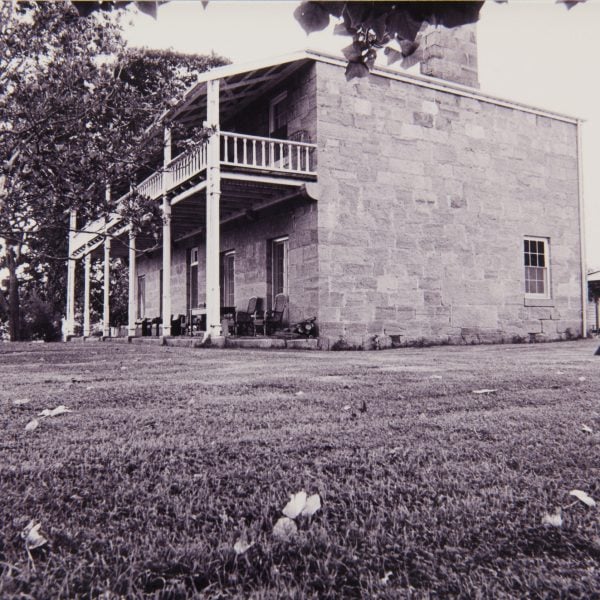 old photo of a two-story sandstone home