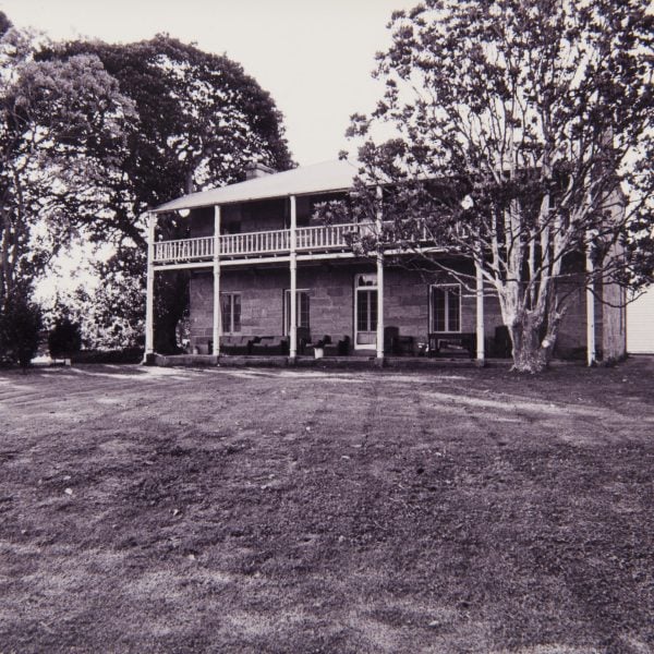 old photo of a two-story sandstone home