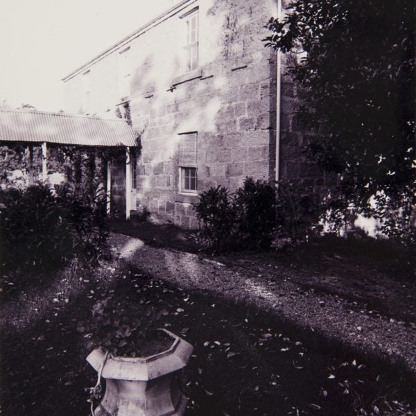 old photo of a two-story sandstone home