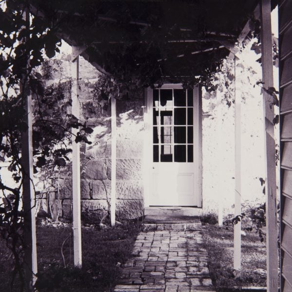 old photo of a two-story sandstone home