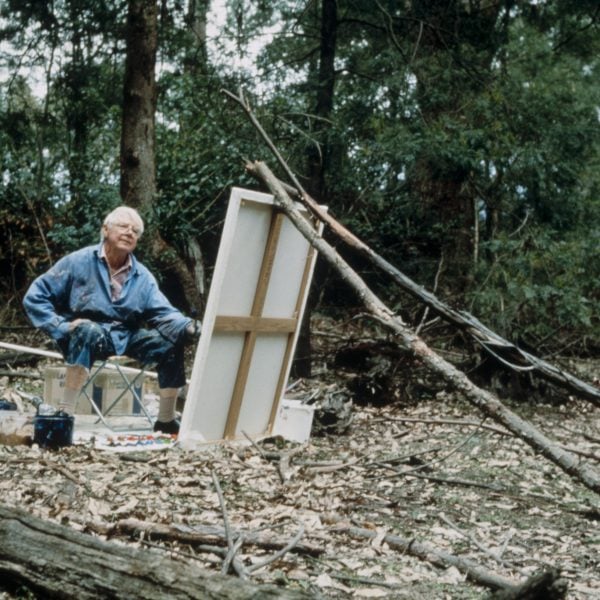 Arthur Boyd painting in on a large canvas in the landscape