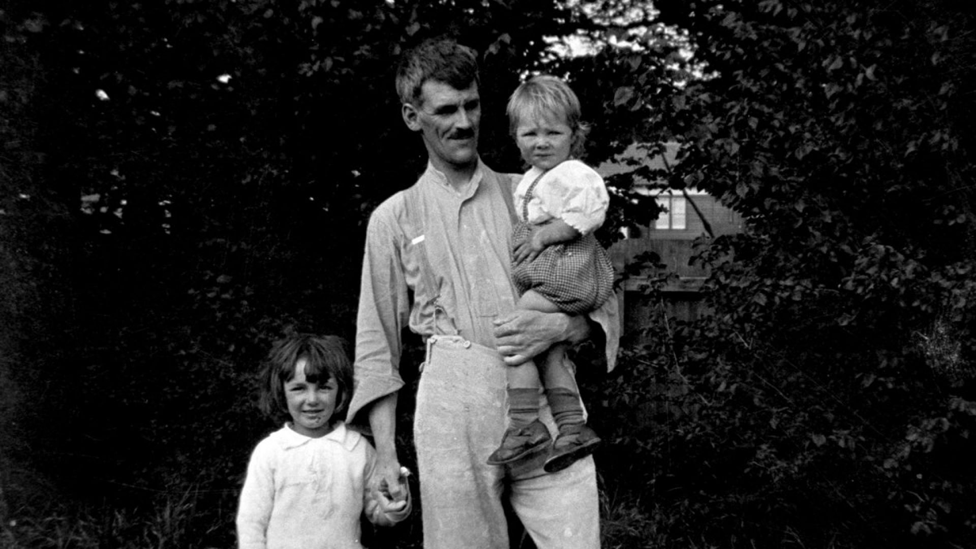 Man with two small children