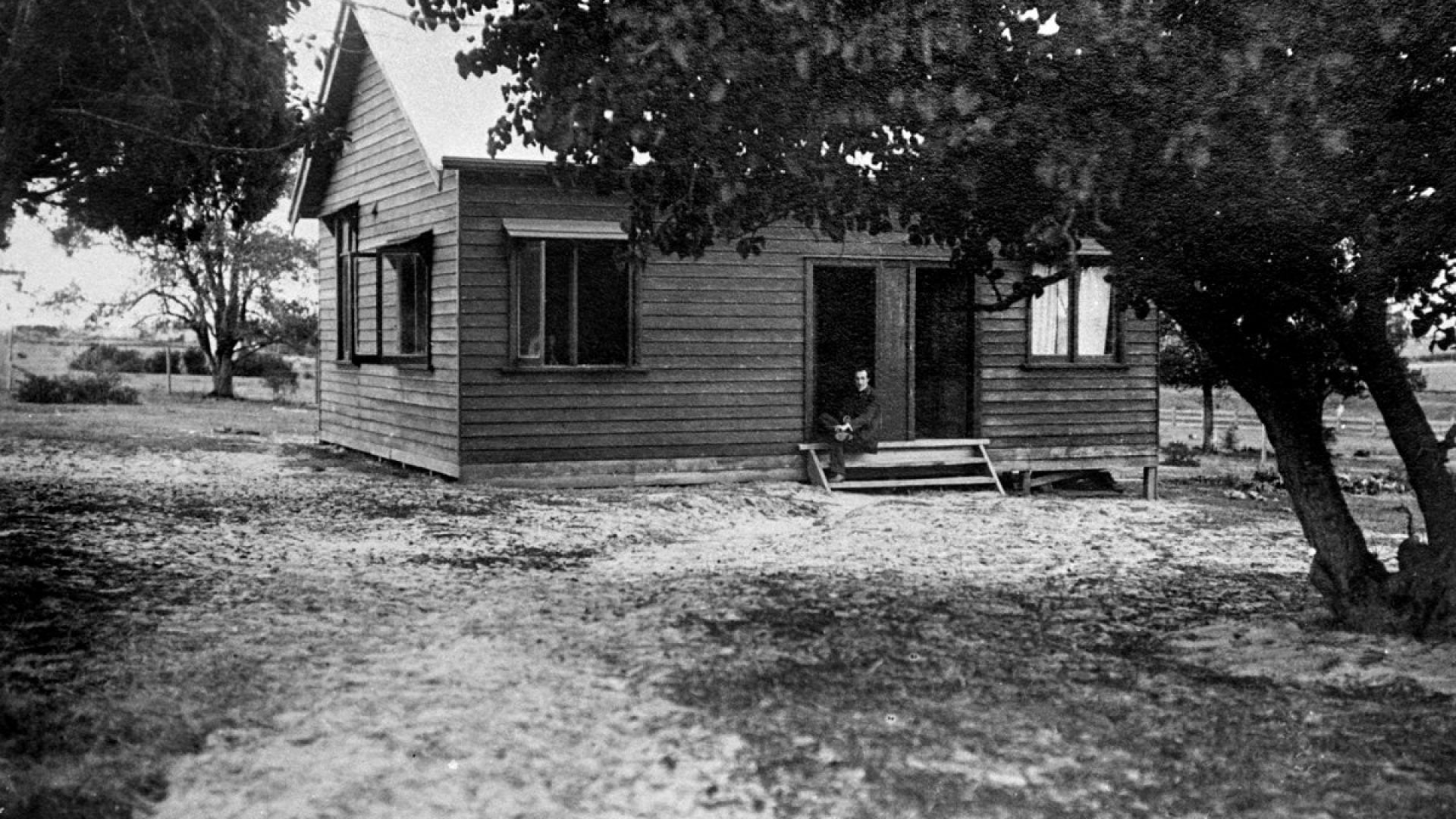 Old photo of a small wooden cottage