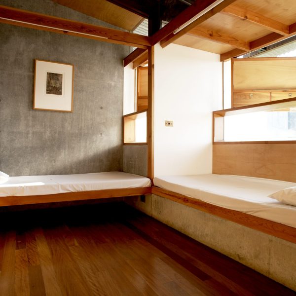 Two beds against walls in a room