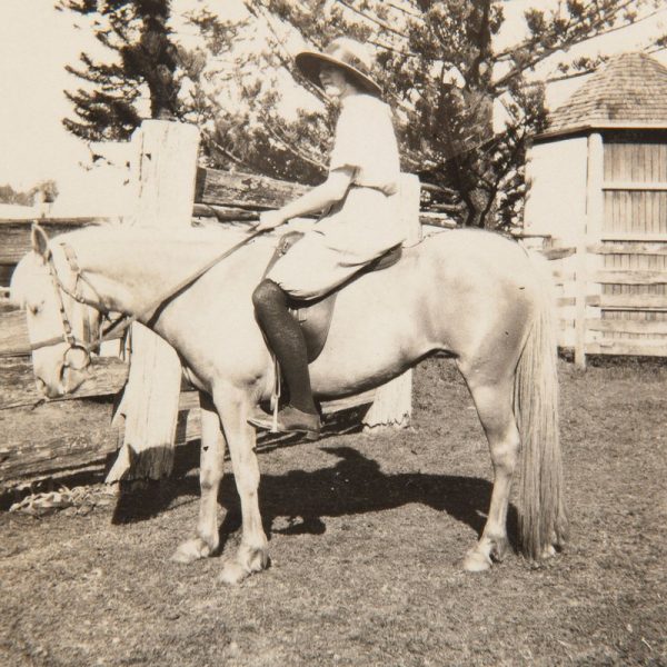 Elinor Dillon (nee Rothwell) on horseback at the western entrance to Bundanon Common with feed stalls in background, c1925. Bundanon Trust Archive, Photo: courtesy Elinor Dillon