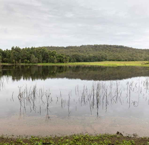 A lake with a mountain range in the background