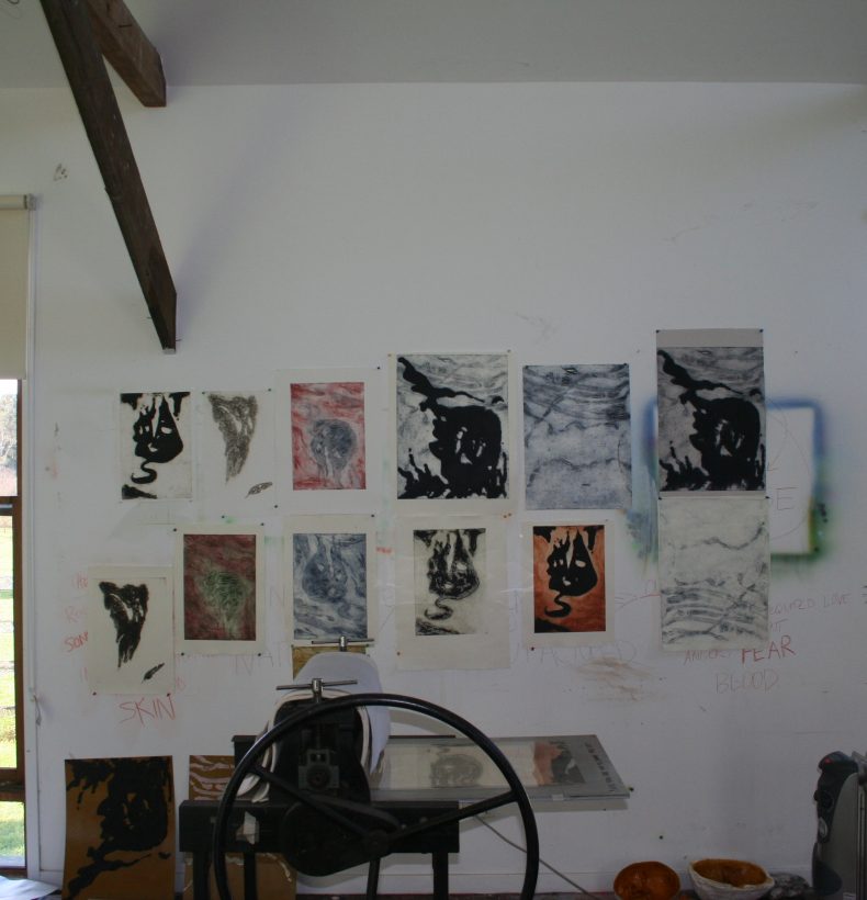 Artist studio with artworks pinned on the wall