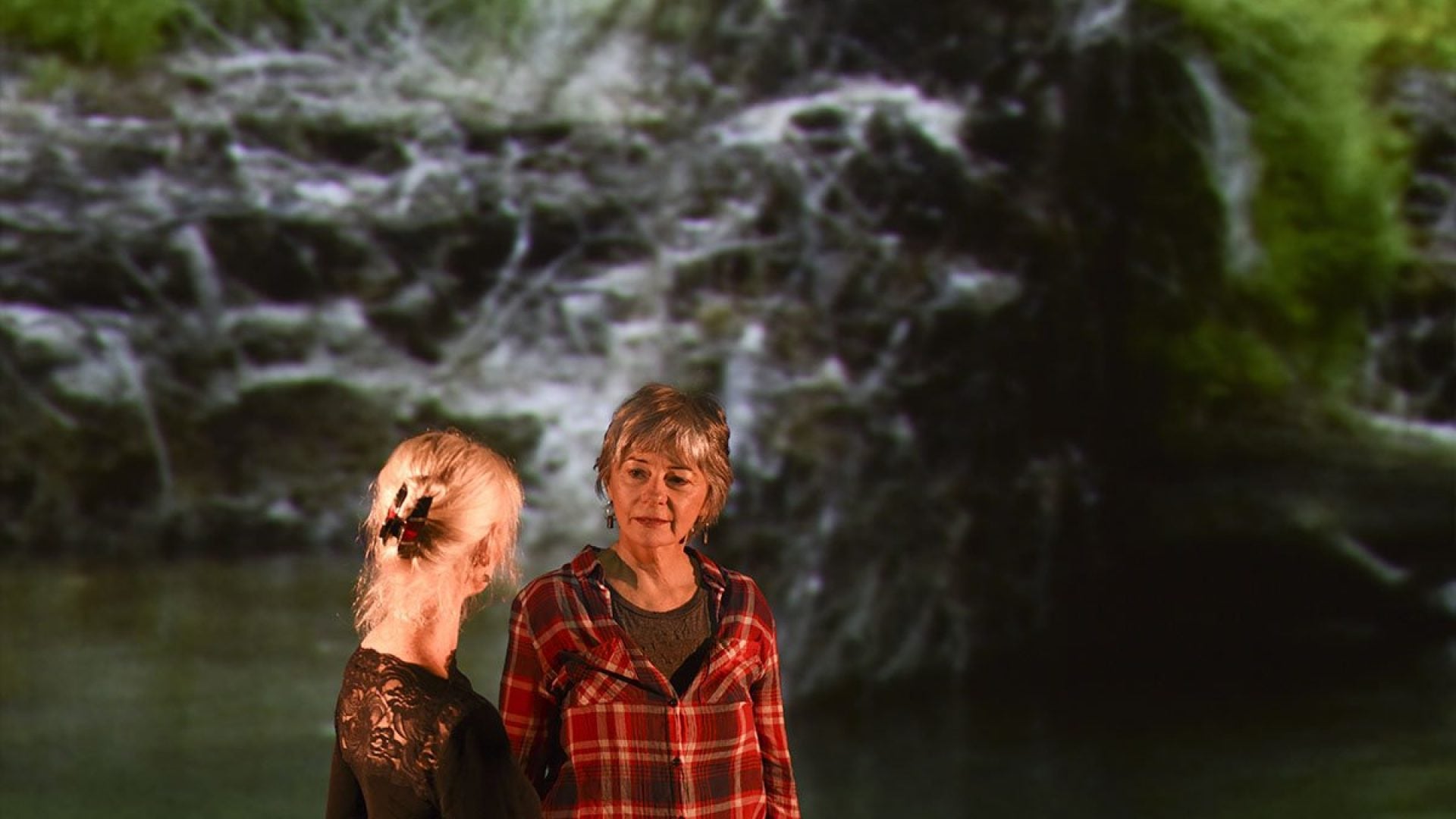Two people standing next to each other looking at each other