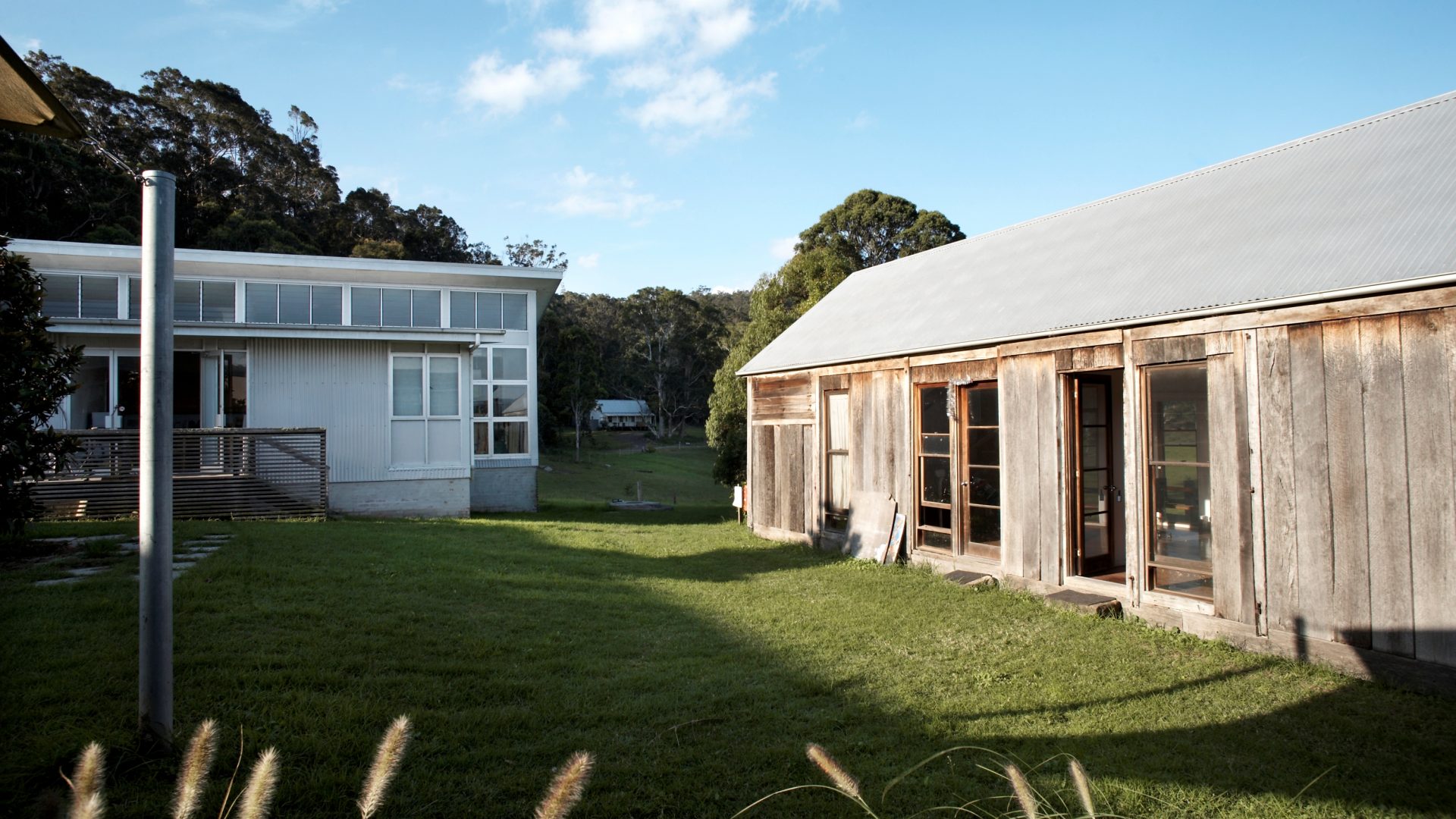 A cluster of small buildings and a courtyard surrounded by bushland