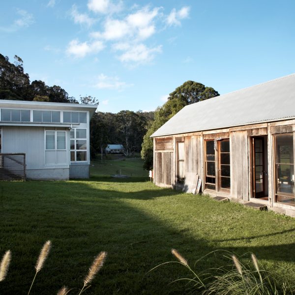 A cluster of small buildings and a courtyard surrounded by bushland