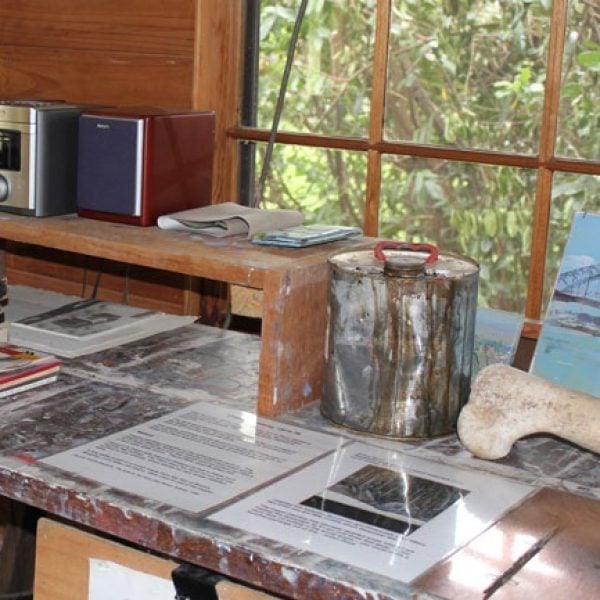 A speaker on a bench with papers