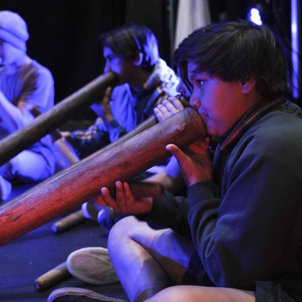 5 young boys playing the didgeridoo