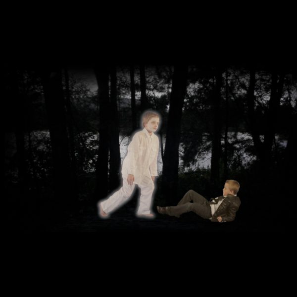 Photograph of 2 illuminated children walking in a dark landscape