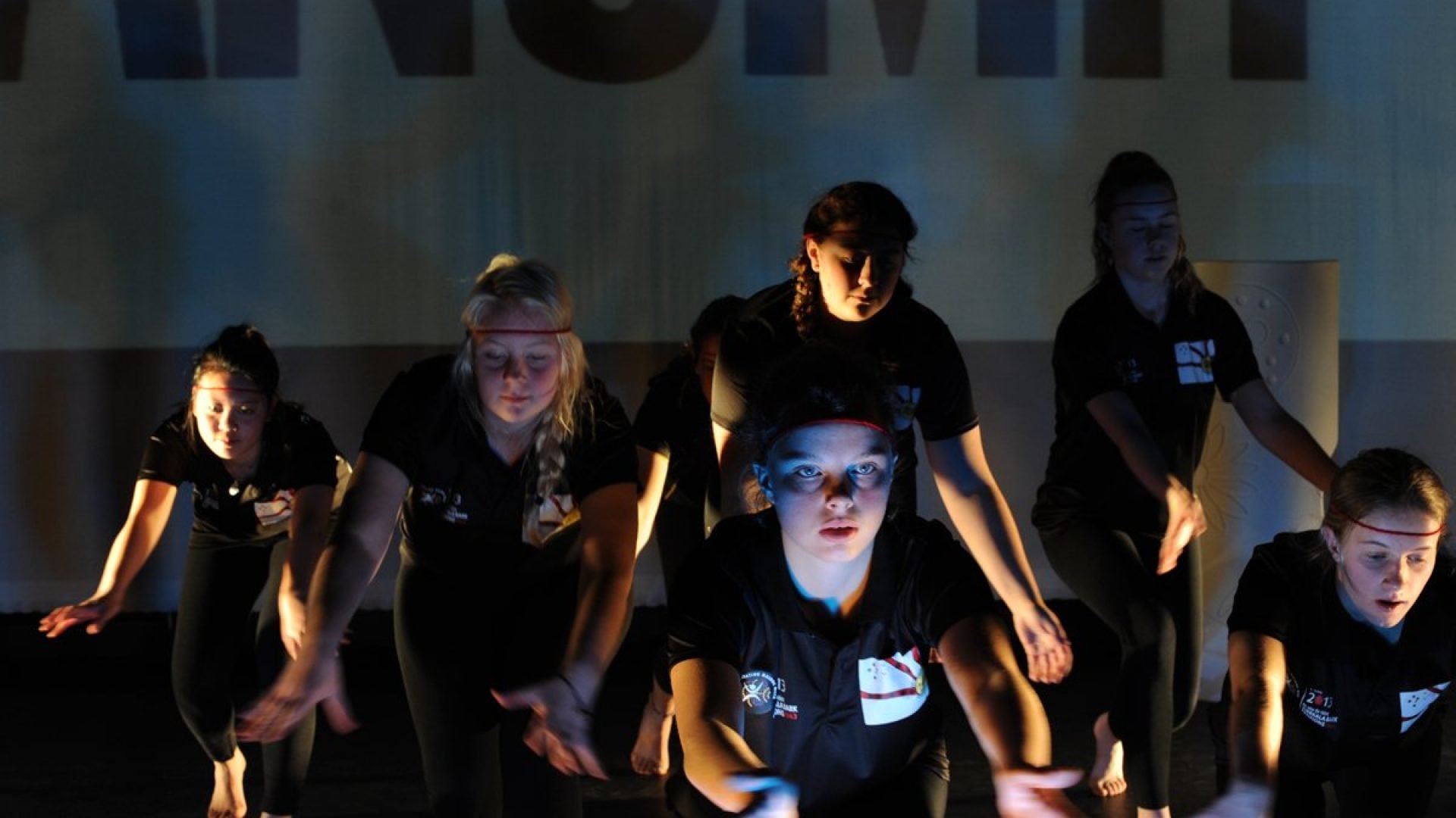 6 young people dancing on stage