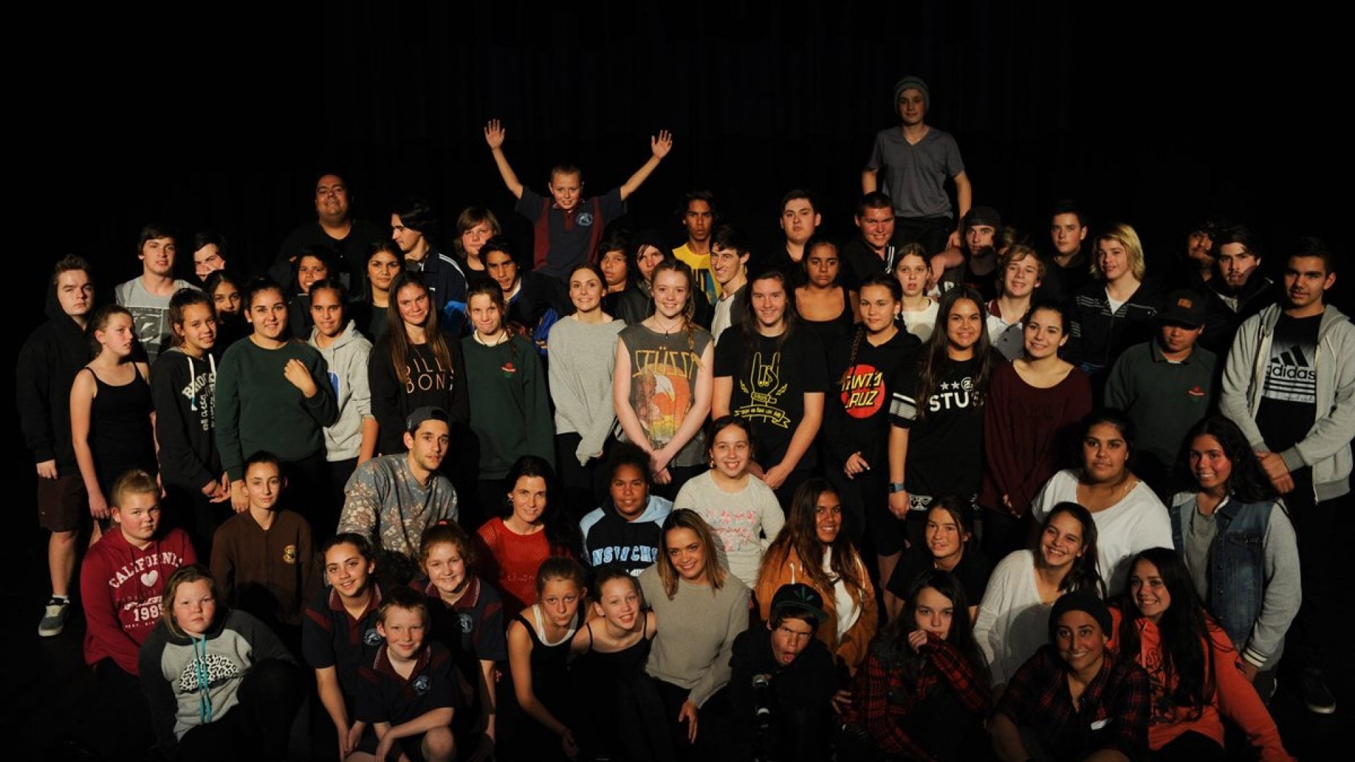 40 young people standing together looking at the camera