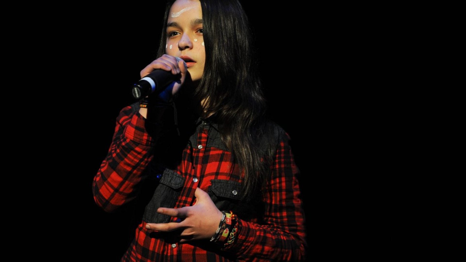 Young girl singing into a microphone