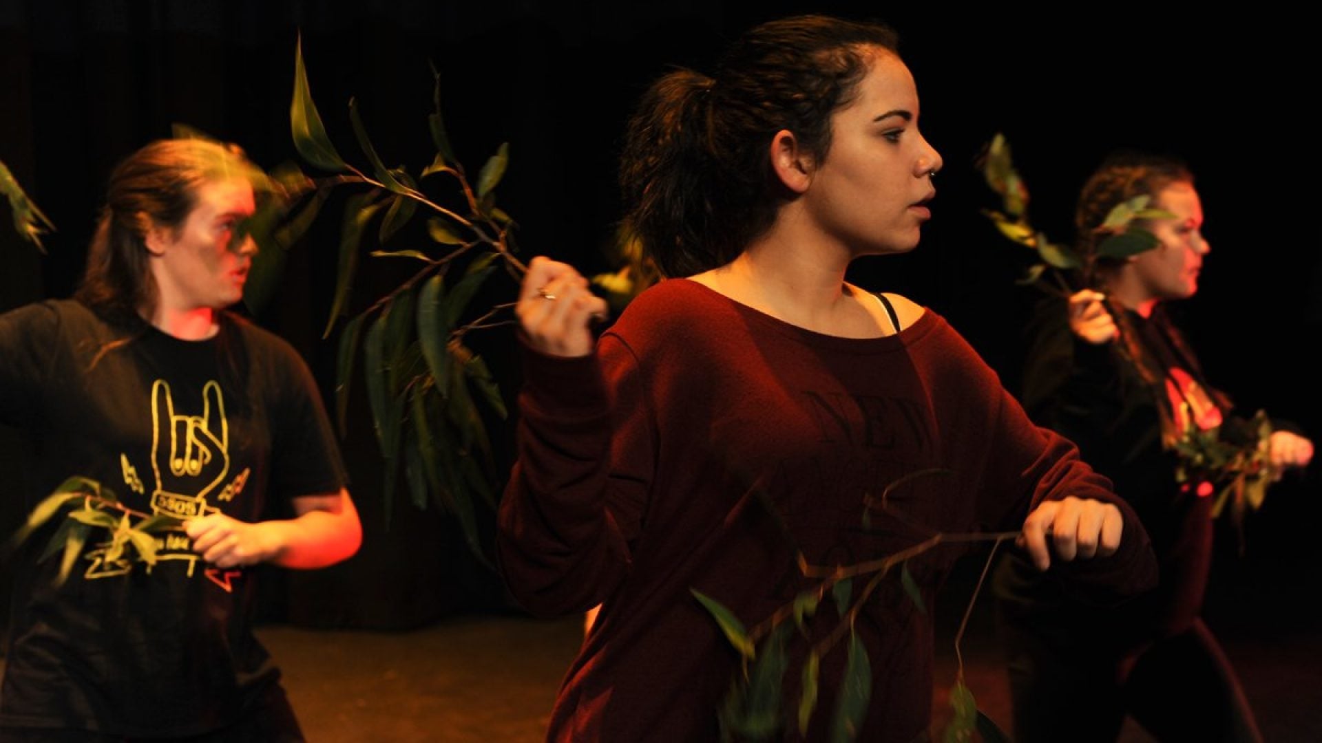 3 girls dancing with leaves in their hands