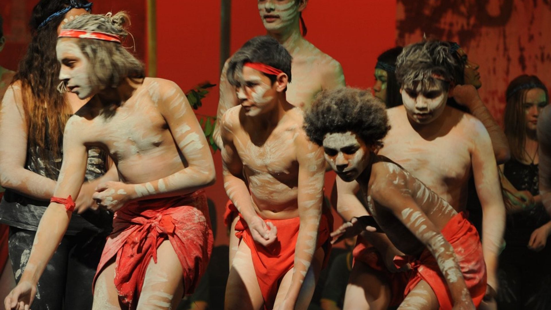 4 young people doing a traditional Aboriginal dance