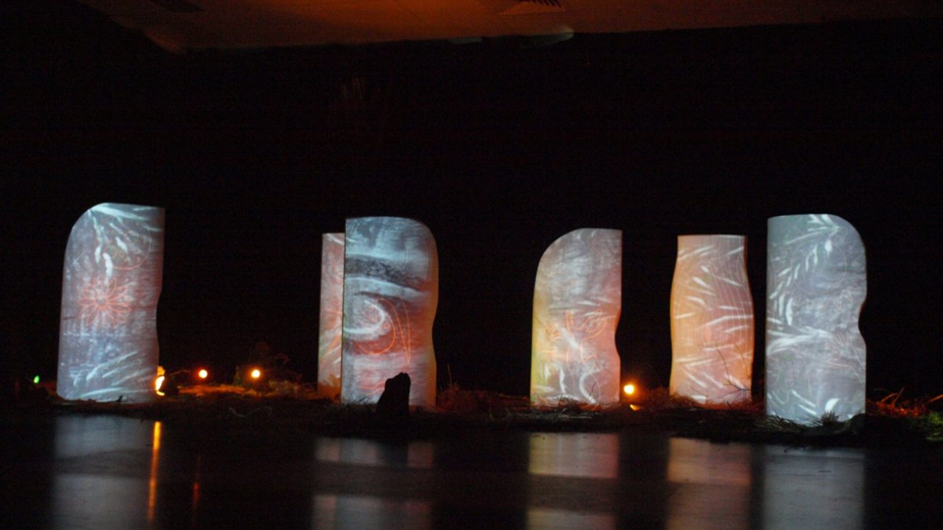 Abstract leave imagery projected on tall white structures