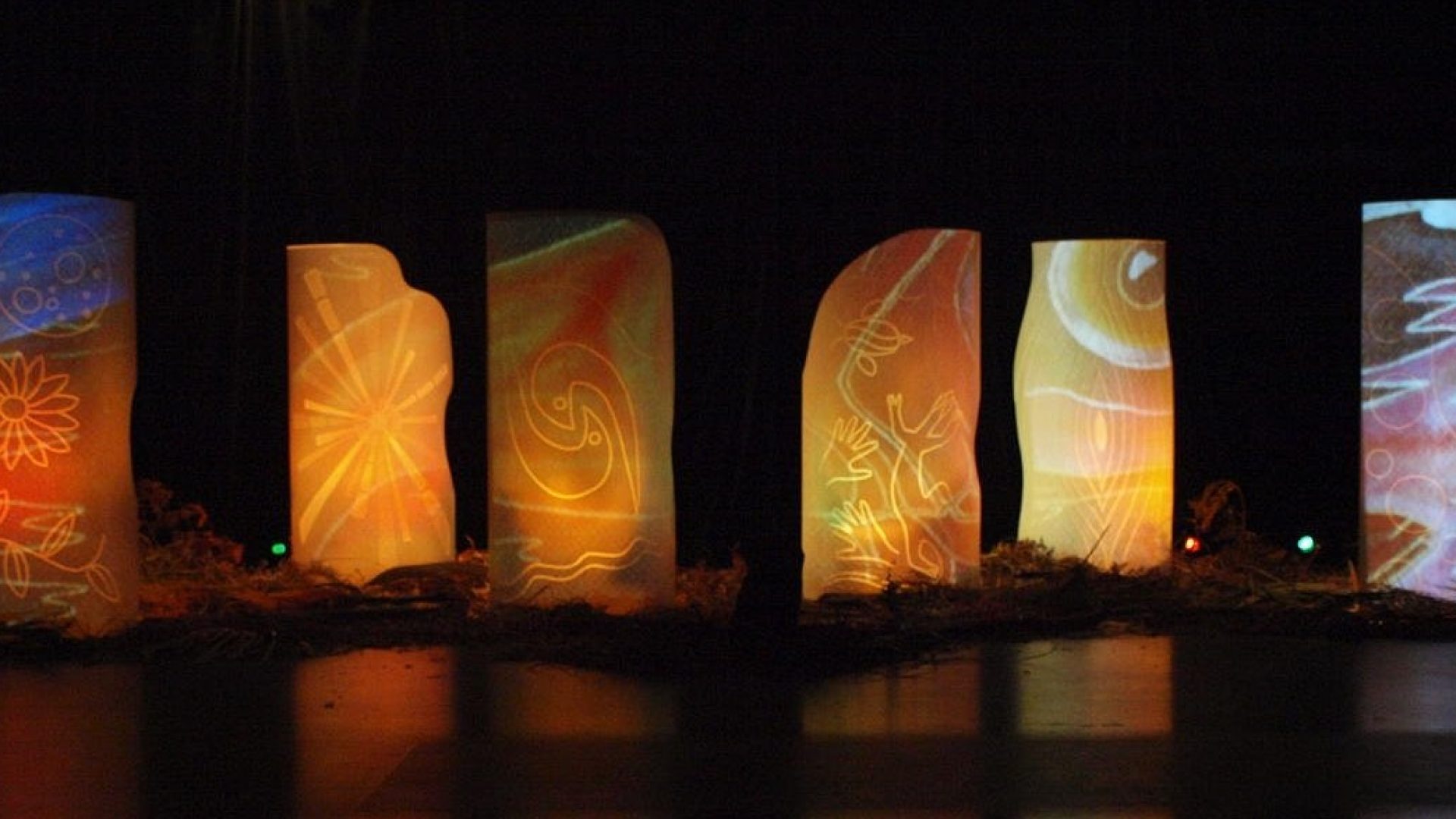 Abstract leave imagery projected on tall white structures