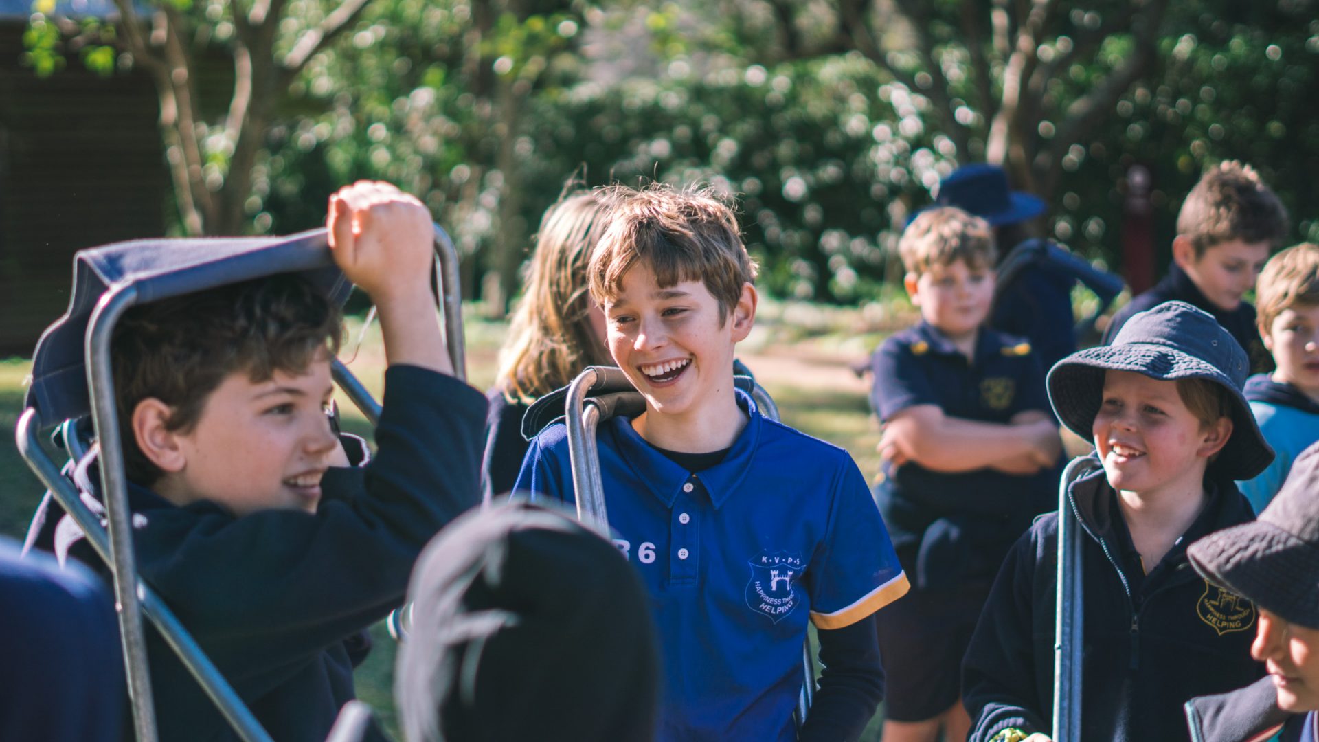 A group of children standing together laughing