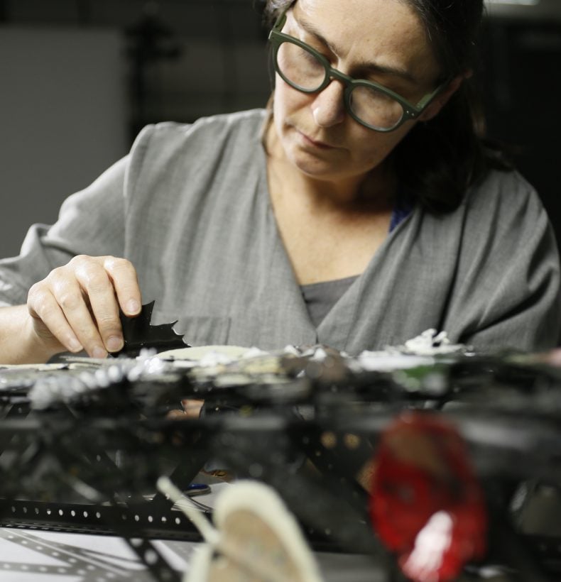 A person in a grey shirt working at a desk