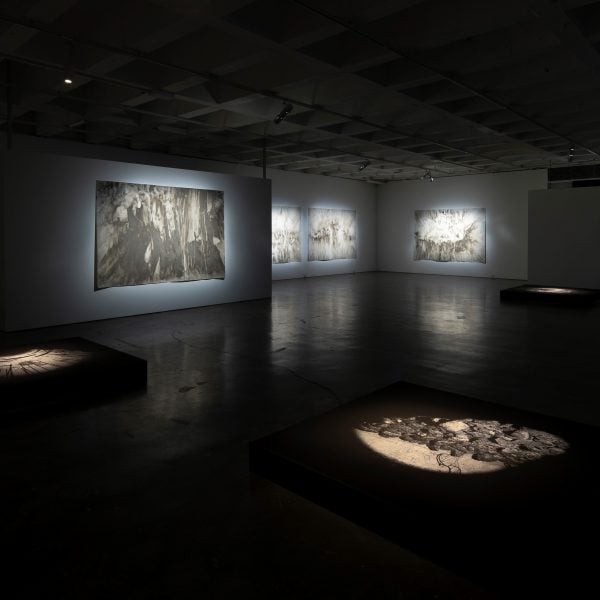 Installation view:
Tin Sheds Gallery, 2021
'Thresholds'
Drawings (wall at rear – four works) 'Thresholds - a chorus'
Site-accreted residue on Heritage rag 320gsm paper,
160 x 240cm each.
Unique digital prints on paper 
2021 (floor in foreground)
150x150 cm
Photo: Richard Glover Photography