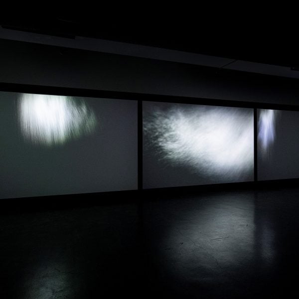 Installation view: Tin Sheds Gallery, 2021
Thresholds: a chorus, 2019.
Three-channel HD video
installation with surround sound,
duration 10:29 mins.
Camera: Richard Glover.
Editing and post-production: Blue Lucine.
Additional editing: Elise Harmsen.
Sound design: Derek Allan, ZigZag Lane.
Producer: Claire Taylor.
Photo: Richard Glover Photography