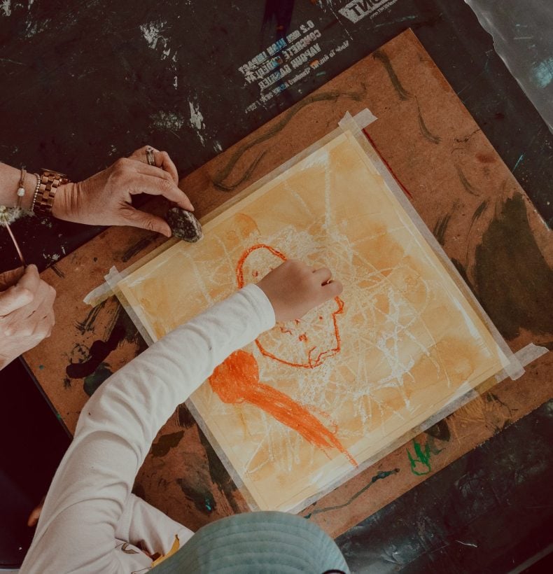 adult and child drawing together