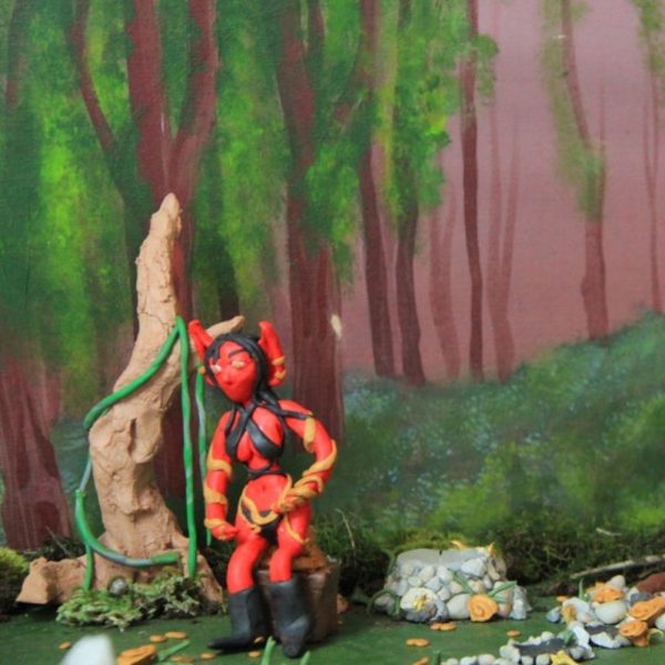 Plasticine figure in forest scene