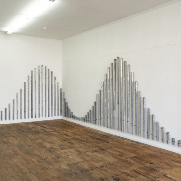Madison Kelly, toko by and by (2022). Marine grade aluminium, hose clamps, mallets and sticks. Photo credit: Blue Oyster Art Project Space