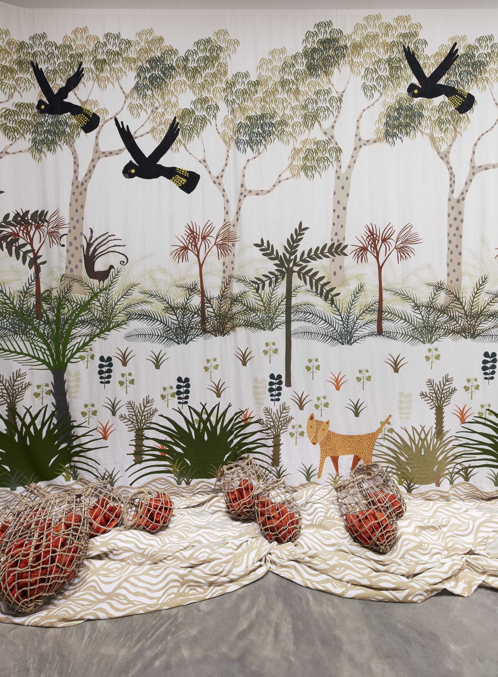 Aunty Cheryl Davison, Dhawa ma lanj bunbal - ba banggawu (Many trees and Burrawangs) , 2024, linen, screenprinting ink, cane, seagrass, hand - dyed fabric with acrylic filling and cotton yarn (installation view) . Photo: Zan Wimberley