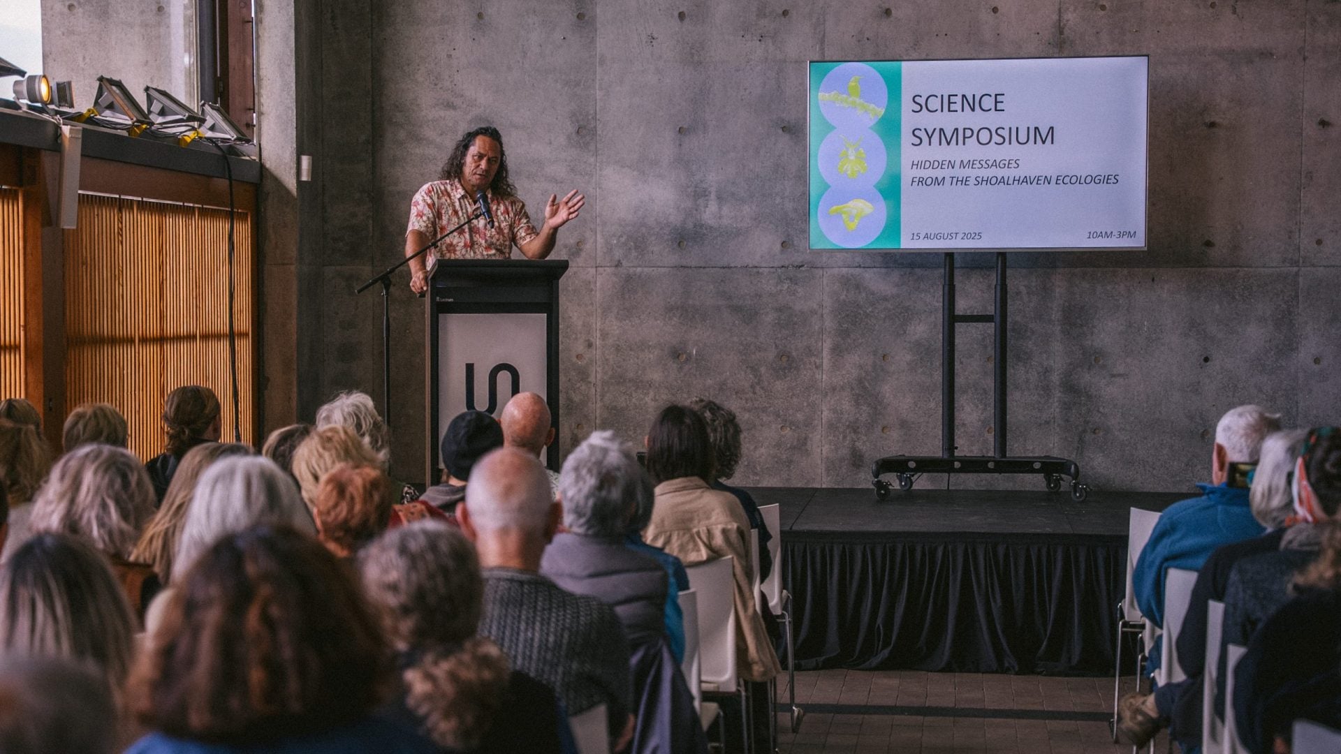 Person speaking at science symposium event.