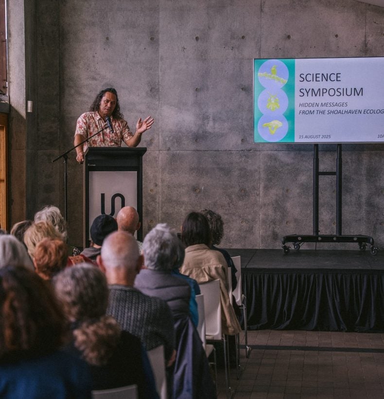 Person speaking at science symposium event.
