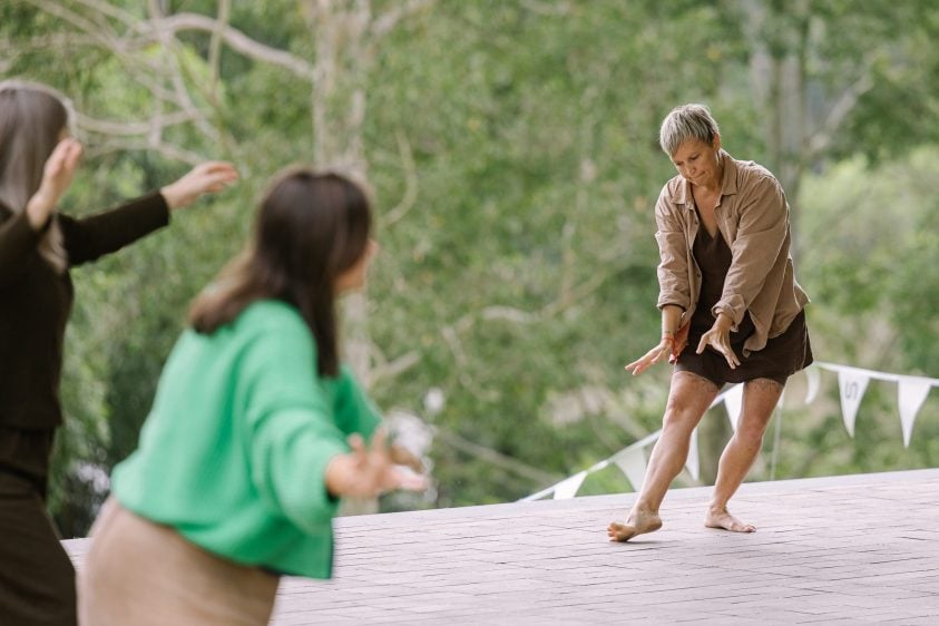 Humans moving together outside.