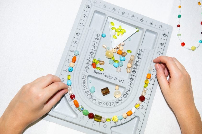 Hands over the top of a bead organiser.