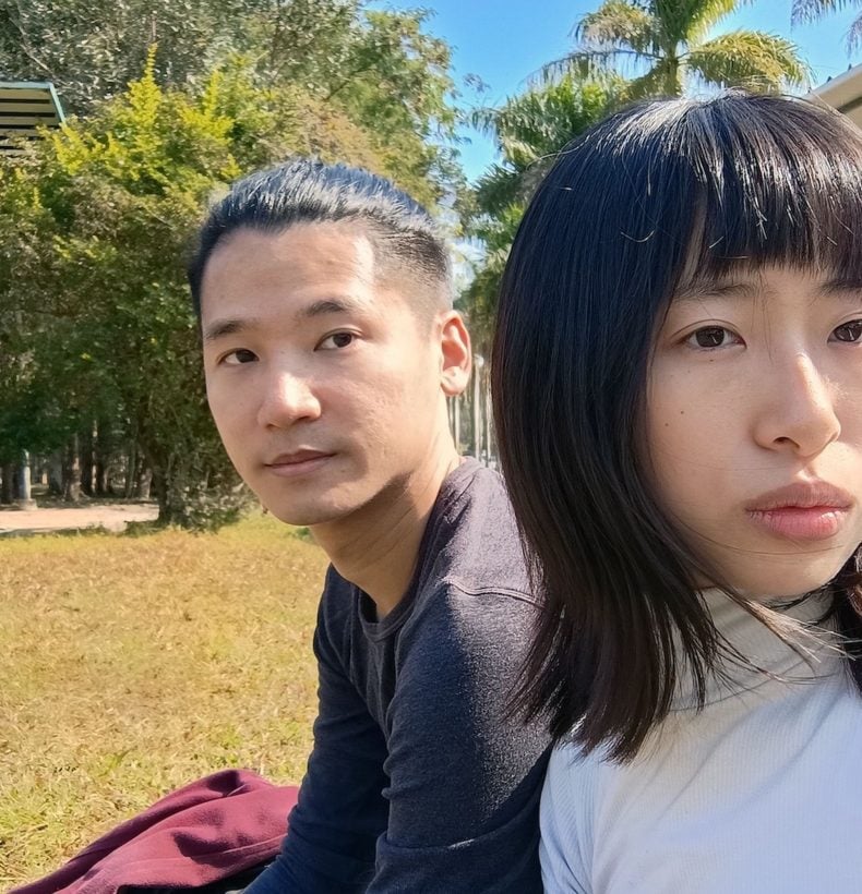 Selfie of two people sitting outside.