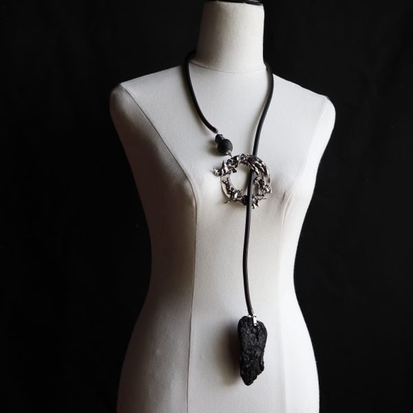 Gina Fairley, Fire: Memory, 2024, Lariat with charred timber, rubber, water cast reclaimed Sterling Silver, lampworked glass beads, cast glass beads, anodised black end caps. Photo: Gina Fairley.