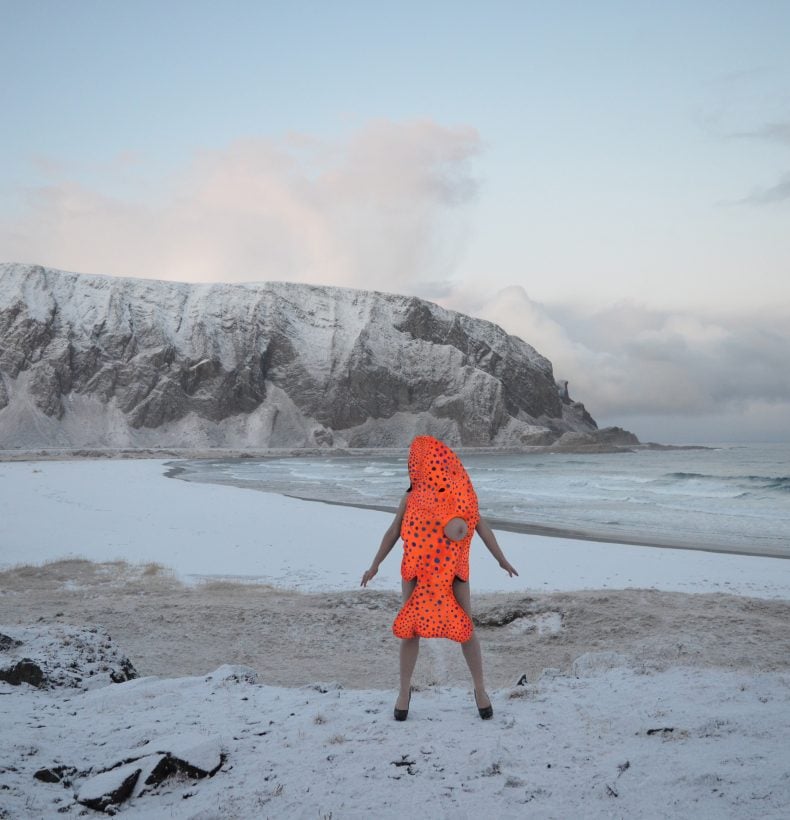 Coral Trout performance artist on a snow-covered beach.