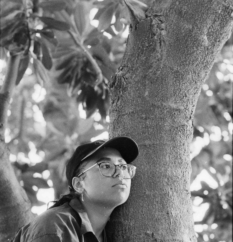 Lilah Bennetti portrait leaning on a tree.