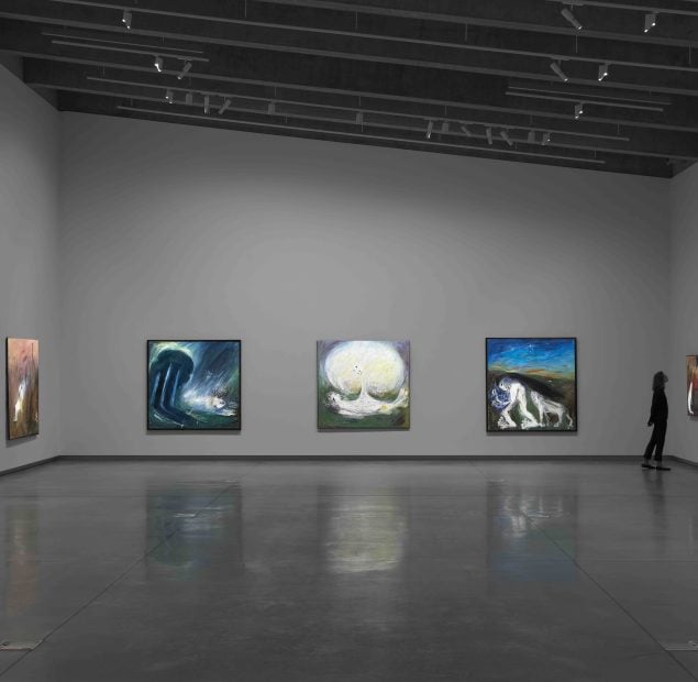 Exhibition display with person viewing work.