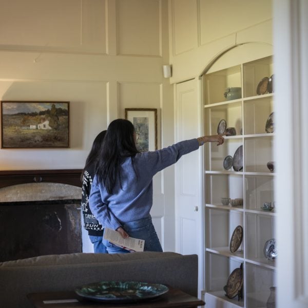 People pointing at objects on display