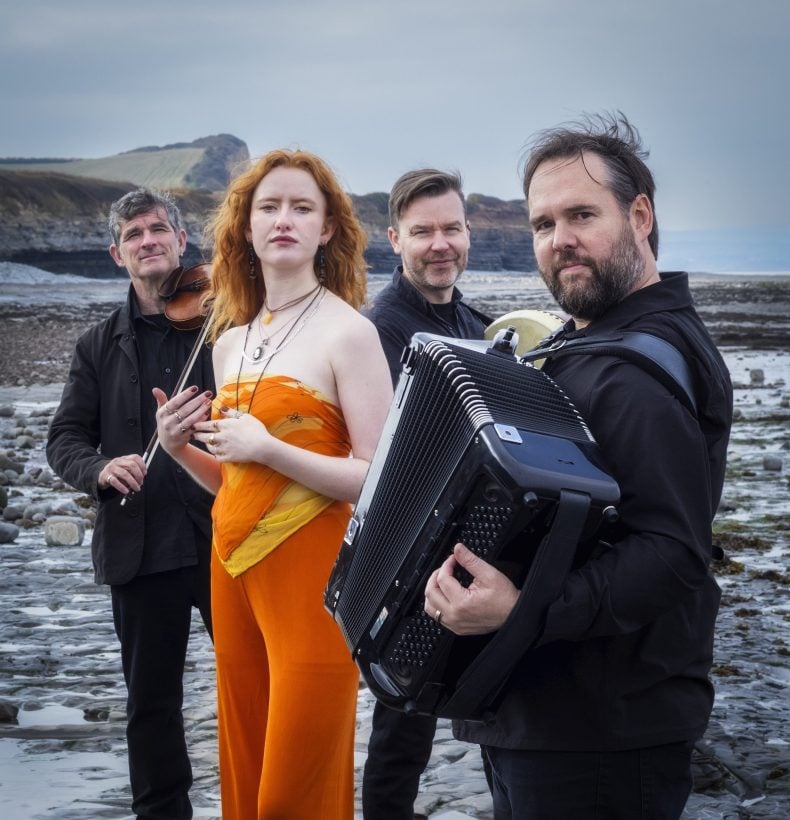 Quartet on the rocky beach with instruments