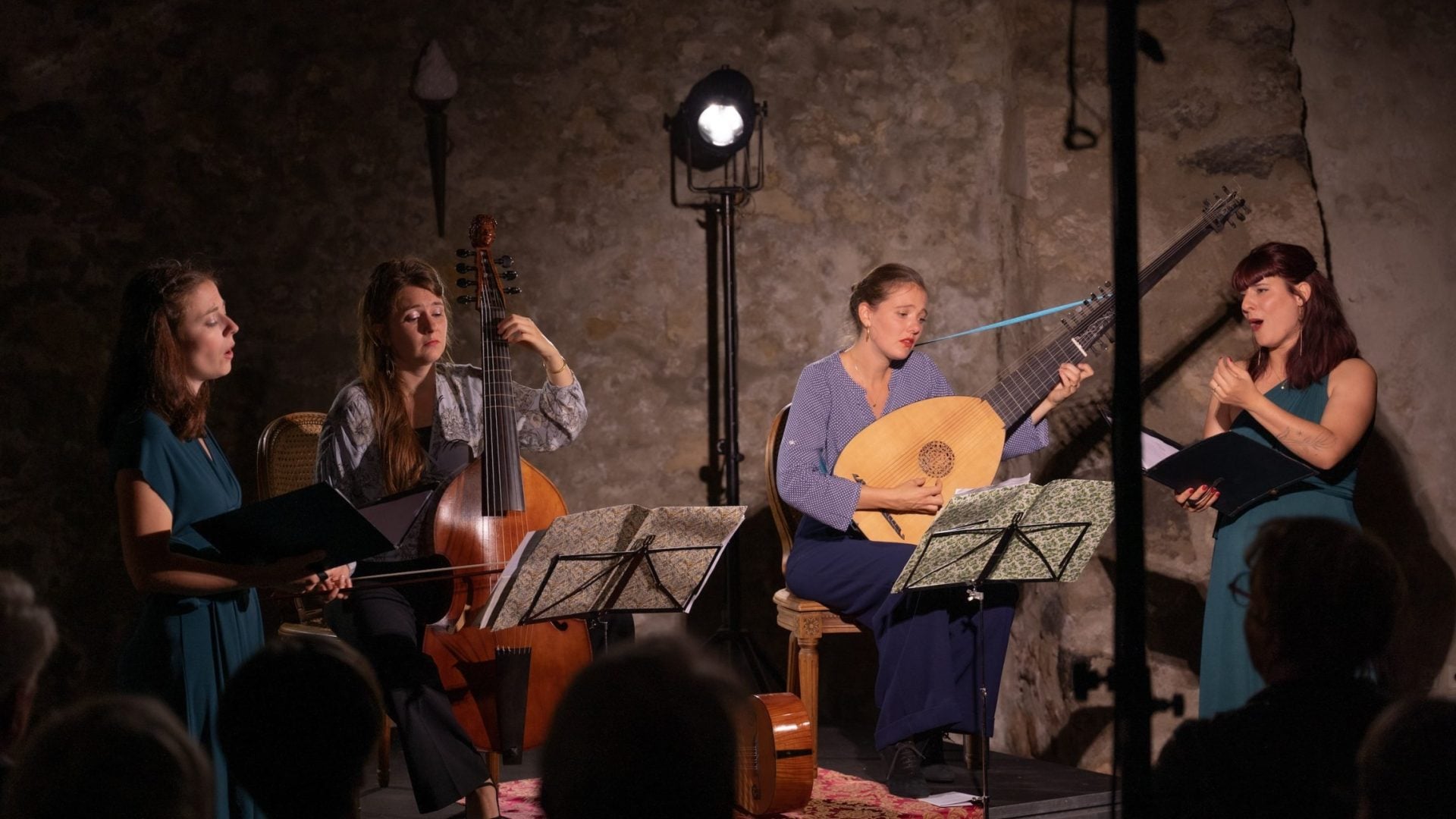 4 women playing music on stage