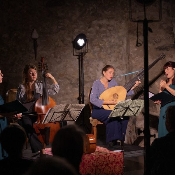 4 women playing music on stage