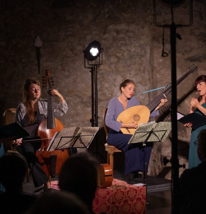 4 women playing music on stage